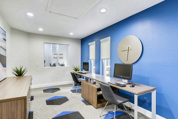 Modern business center with sleek workstations at Park Place at 92nd Apartments clubhouse