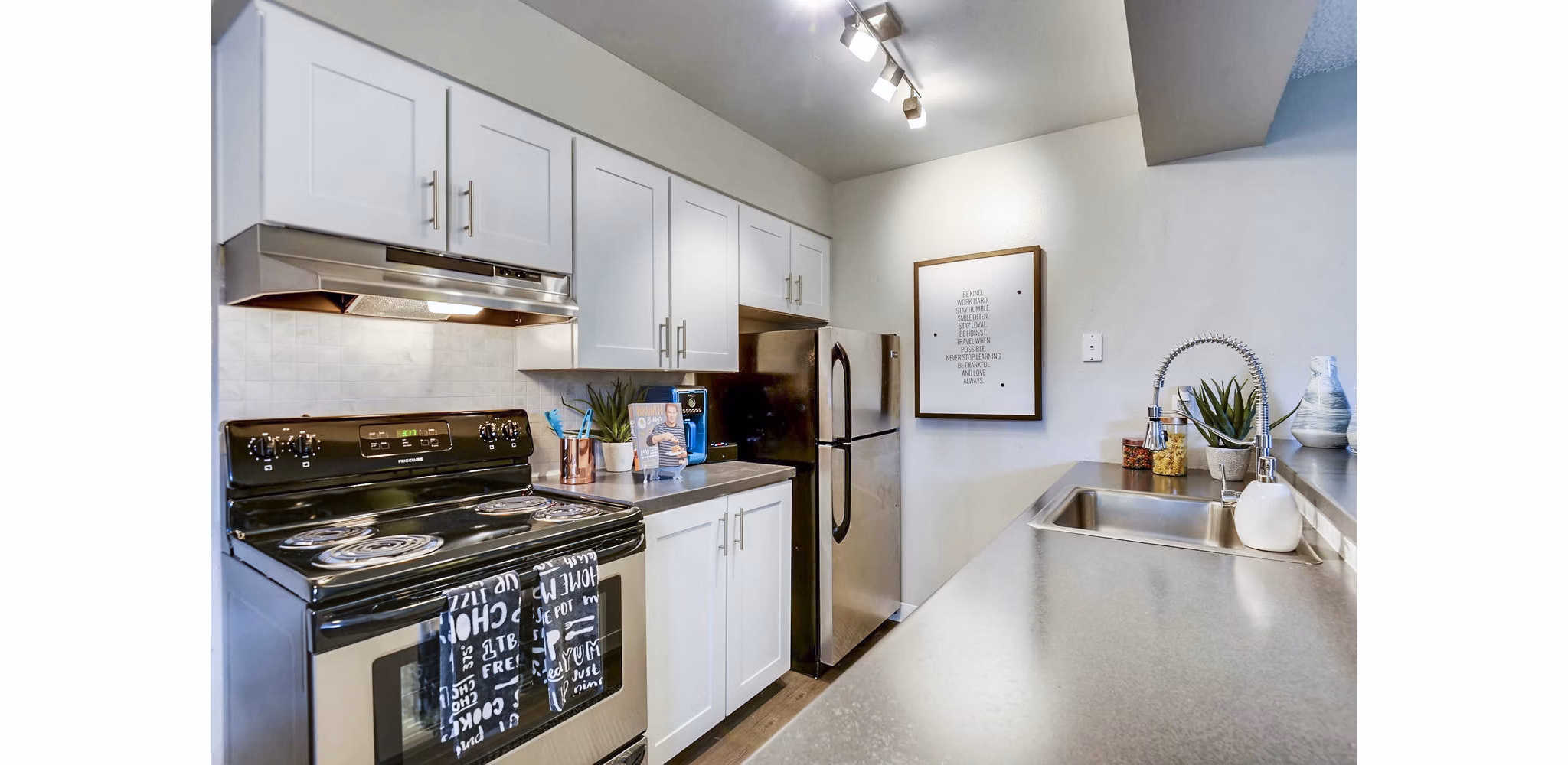 Modern kitchen with stainless steel appliances at Park Place at 92nd Apartments luxury rentals