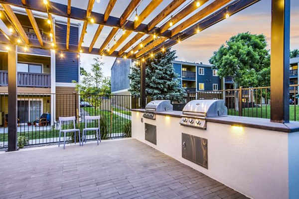 Spacious pool and grill area at Park Place at 92nd Apartments offering a relaxing outdoor experience