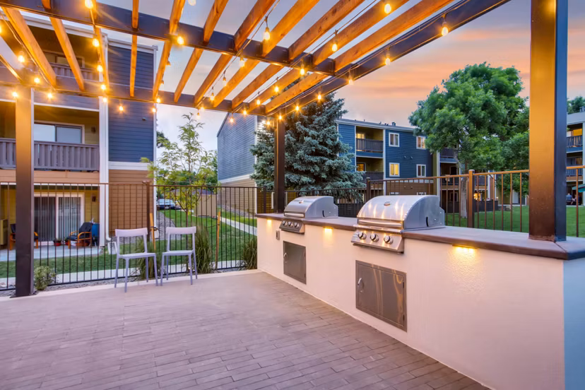 Community pool and grill area at Park Place at 92nd Apartments, ideal for social gatherings and relaxation