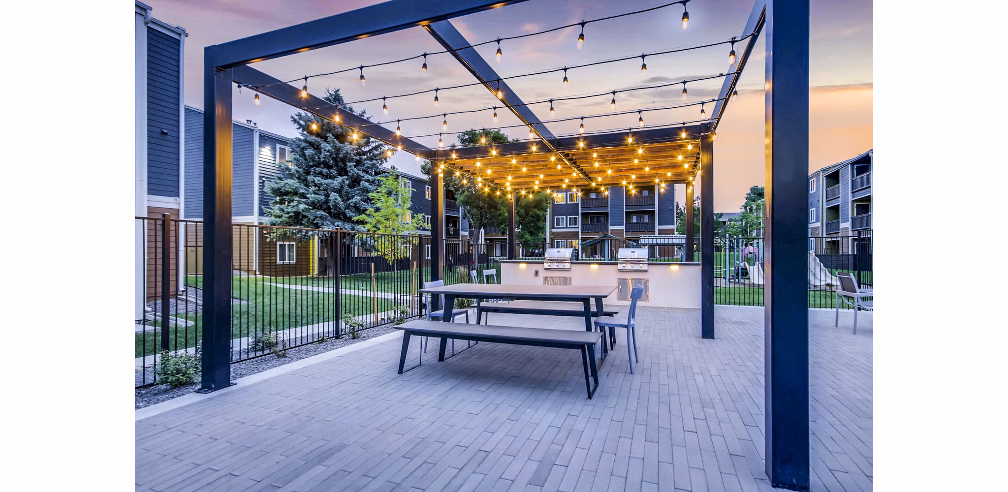 Community pool and grill area at Park Place at 92nd Apartments, ideal for social gatherings and relaxation