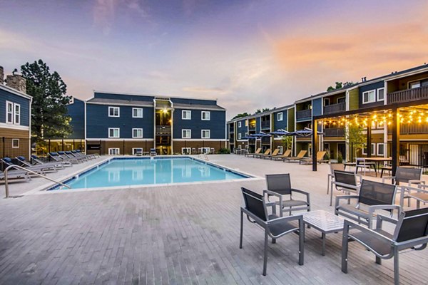 Resort-style pool with sun loungers at Park Place at 92nd Apartments