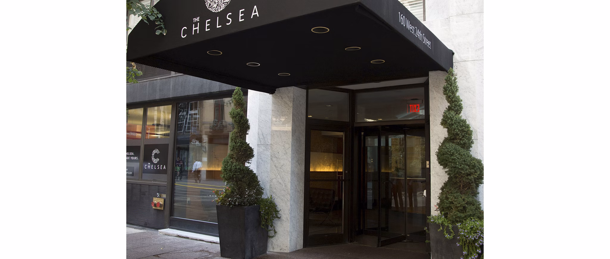 Entrance of The Chelsea building with black awning at The Chelsea Apartments
