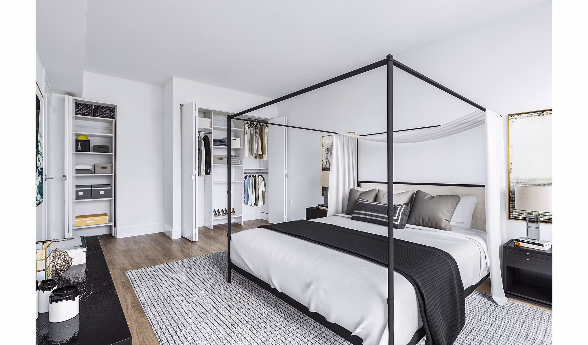 Minimalist bedroom with canopy bed, open closet, and neutral decor at The Chelsea Apartments