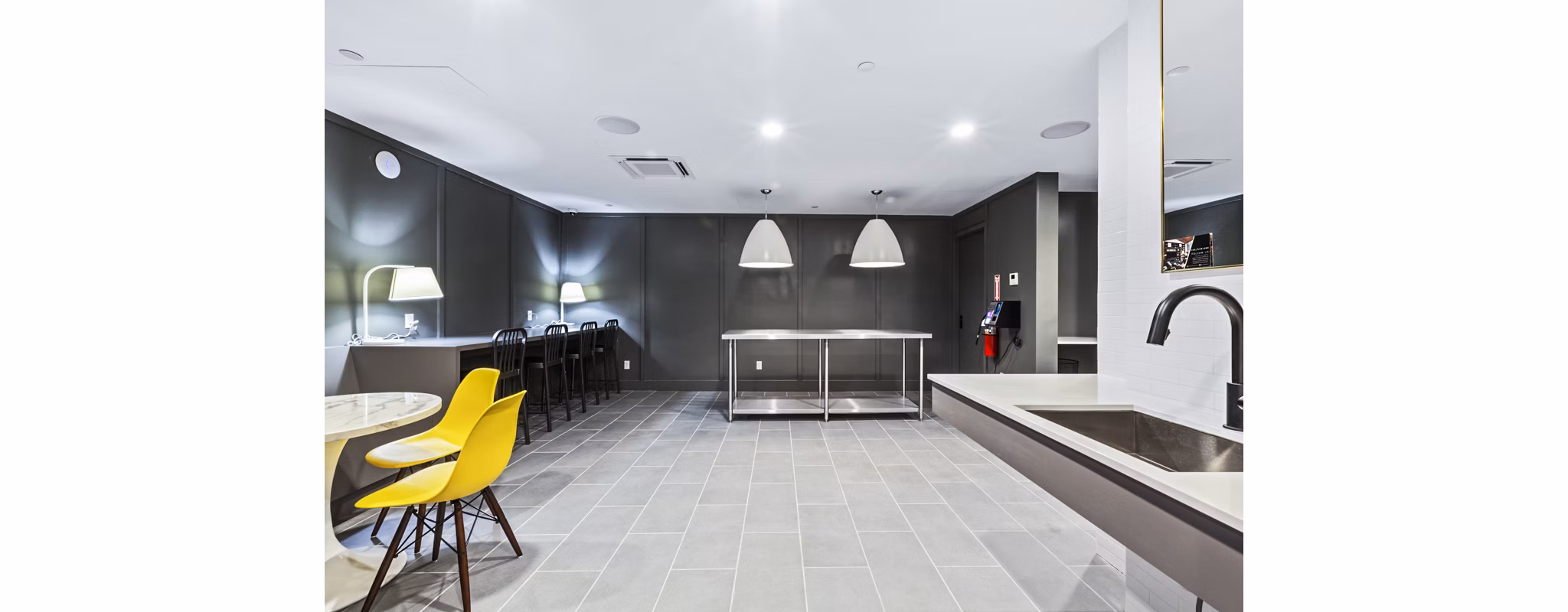 Living room with large bookshelf, TV, and seating area at The Chelsea Apartments