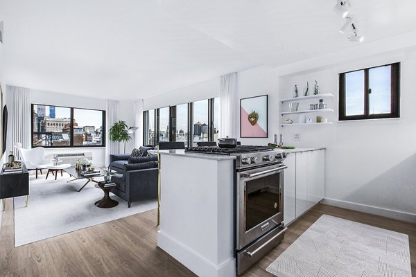 Bright, open-concept kitchen and living area with city views at The Chelsea Apartments