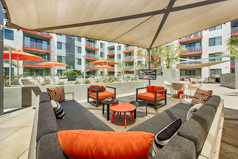 Stylish outdoor patio with modern furnishings at The Tomscot Apartments, perfect for relaxing amidst luxury surroundings