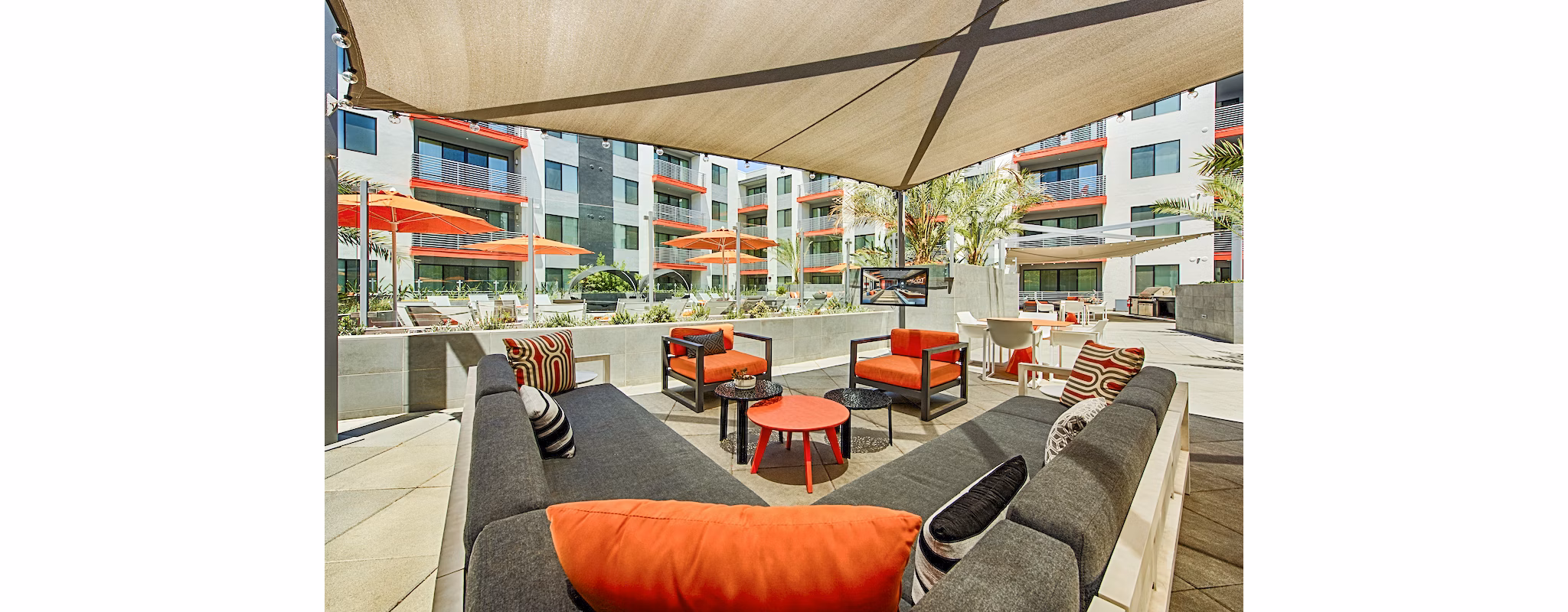 Stylish outdoor patio with modern furnishings at The Tomscot Apartments, perfect for relaxing amidst luxury surroundings