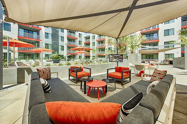 Stylish outdoor patio with modern furnishings at The Tomscot Apartments, perfect for relaxing amidst luxury surroundings