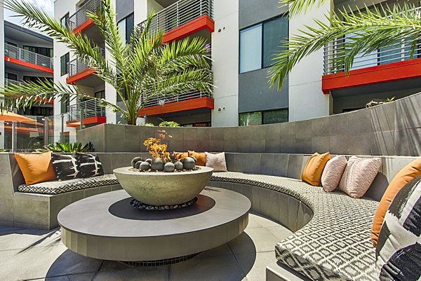 Cozy fire pit on modern patio at The Tomscot Apartments, creating a welcoming outdoor gathering space