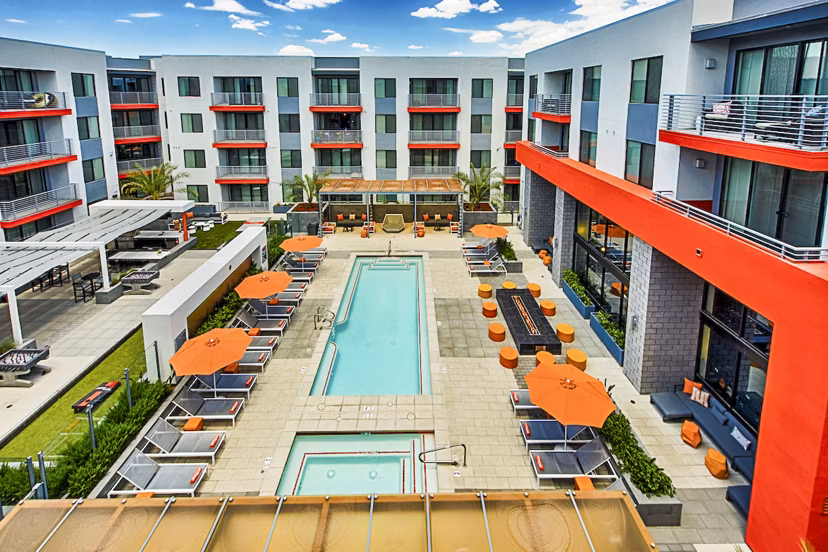 Luxurious poolside retreat at The Tomscot Apartments featuring cabanas and lounge seating