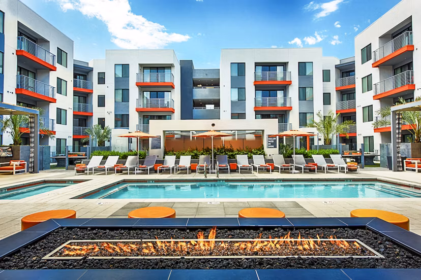 Modern outdoor pool with lounge chairs at The Tomscot Apartments in Scottsdale, ideal for relaxation and sunbathing