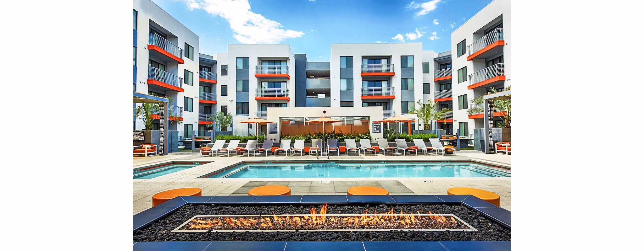 Modern outdoor pool with lounge chairs at The Tomscot Apartments in Scottsdale, ideal for relaxation and sunbathing