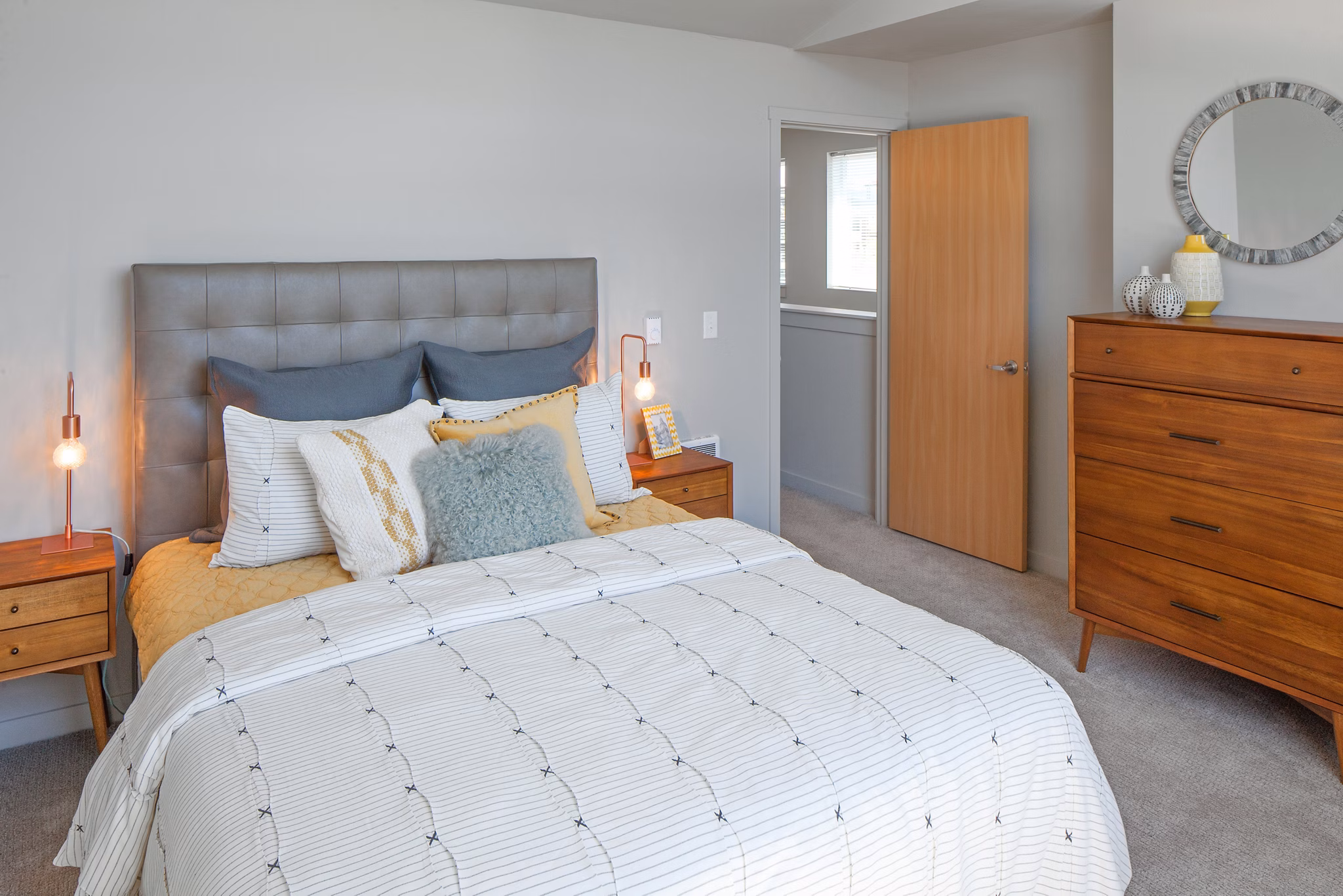 Cozy bedroom with modern decor at The Tennyson at Crescent Village Apartments