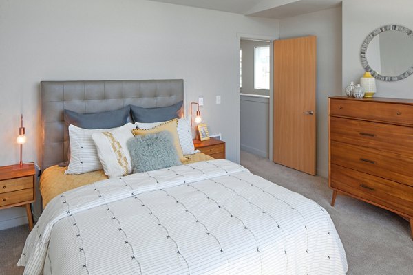 Cozy bedroom with modern decor at The Tennyson at Crescent Village Apartments