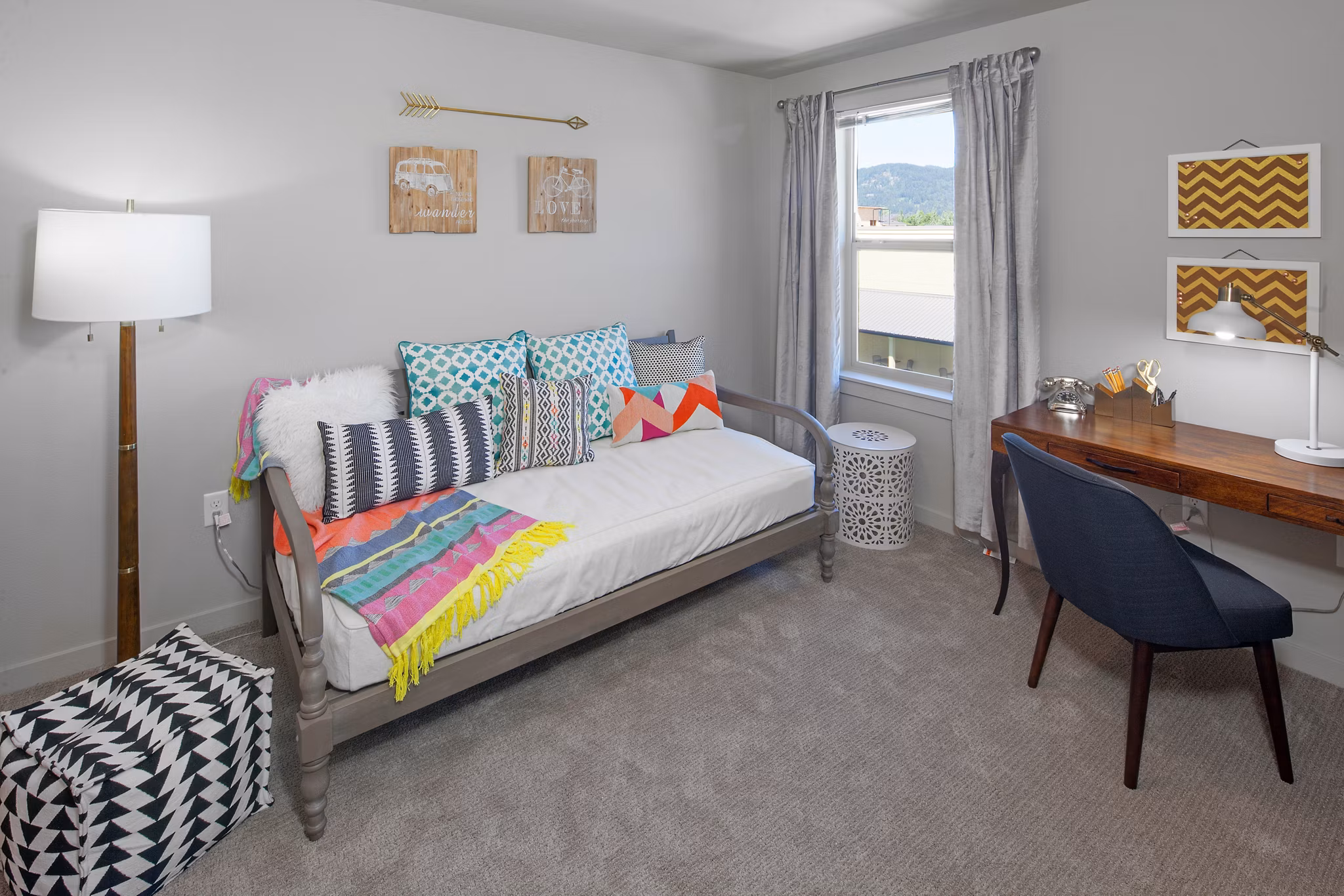 Cozy bedroom with natural light and modern decor at The Tennyson at Crescent Village Apartments