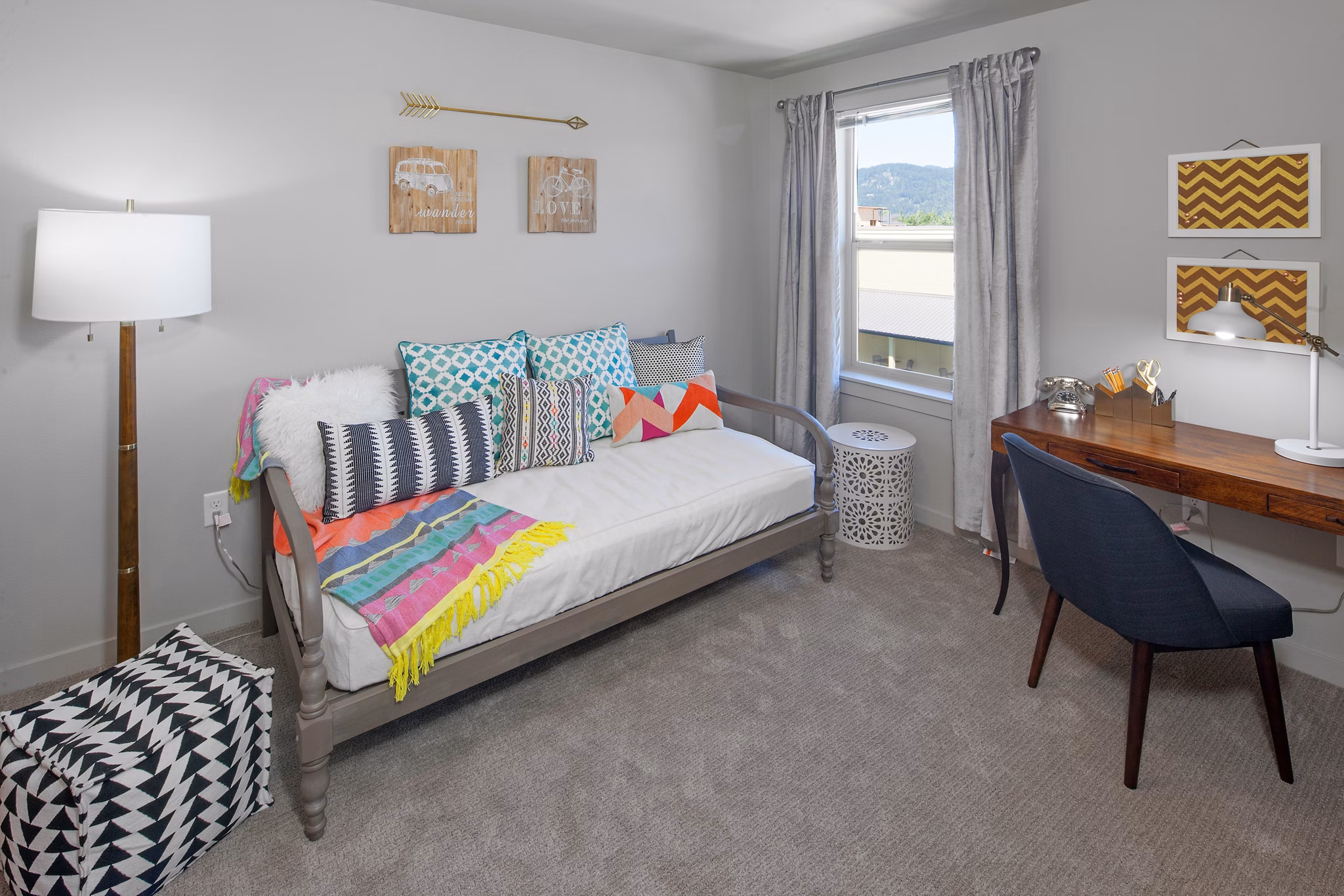 Cozy bedroom with natural light and modern decor at The Tennyson at Crescent Village Apartments