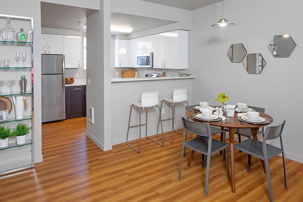 Elegant dining room with modern furnishings at The Tennyson at Crescent Village Apartments