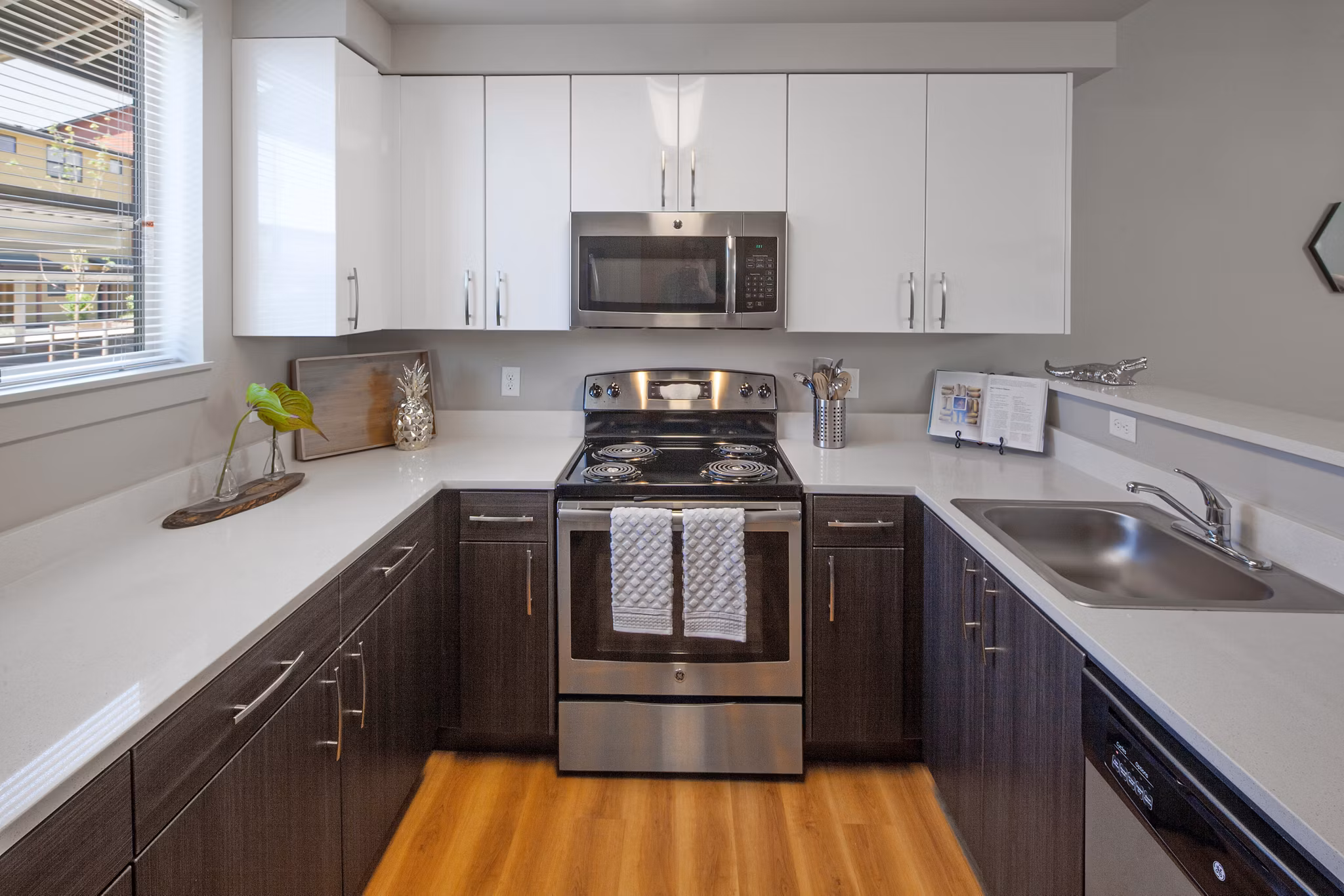 Modern kitchen with stainless steel appliances at The Tennyson at Crescent Village Apartments, offering luxury living spaces in a desirable location