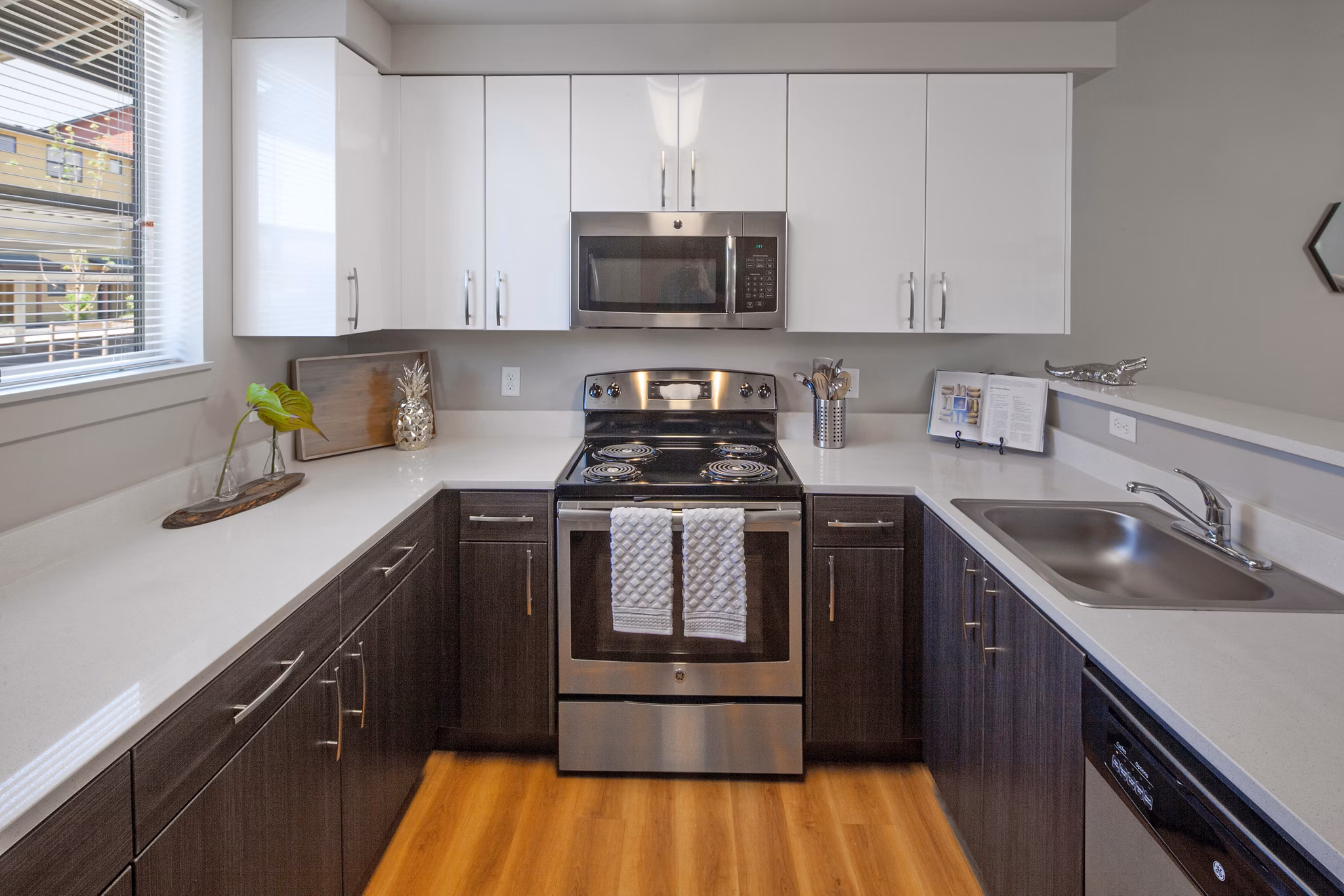 Modern kitchen with stainless steel appliances at The Tennyson at Crescent Village Apartments, offering luxury living spaces in a desirable location