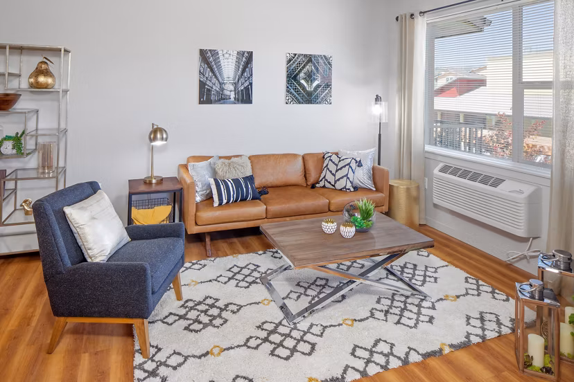 Modern living room with stylish furnishings at The Tennyson at Crescent Village Apartments