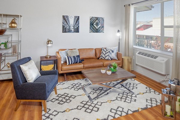 Modern living room with stylish furnishings at The Tennyson at Crescent Village Apartments