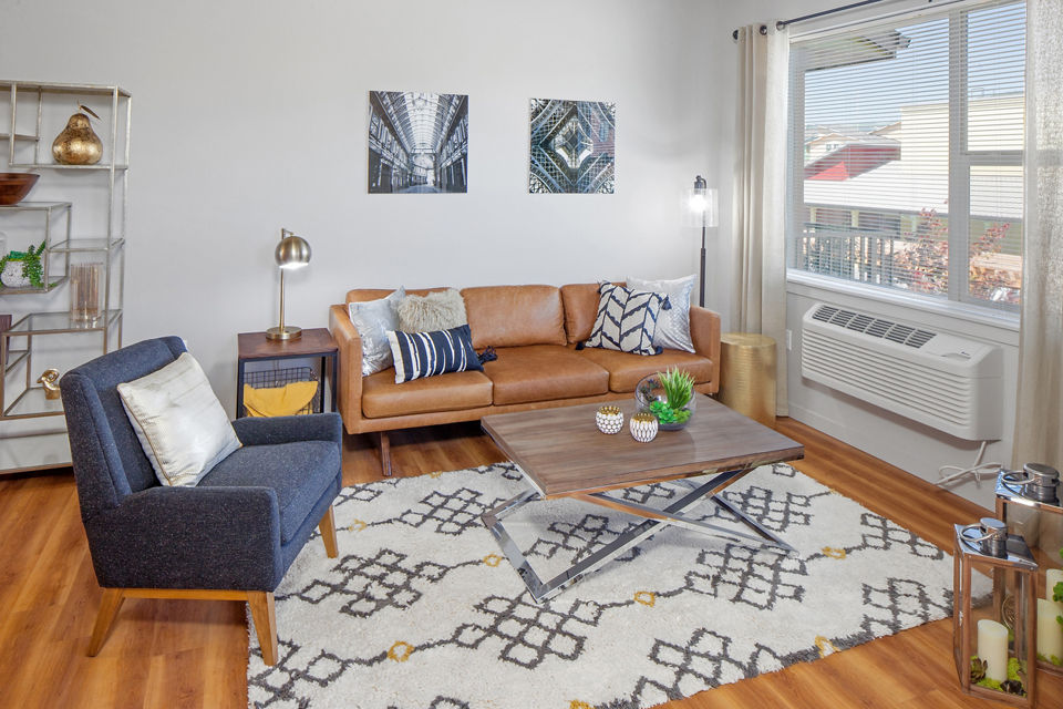 Modern living room with stylish furnishings at The Tennyson at Crescent Village Apartments