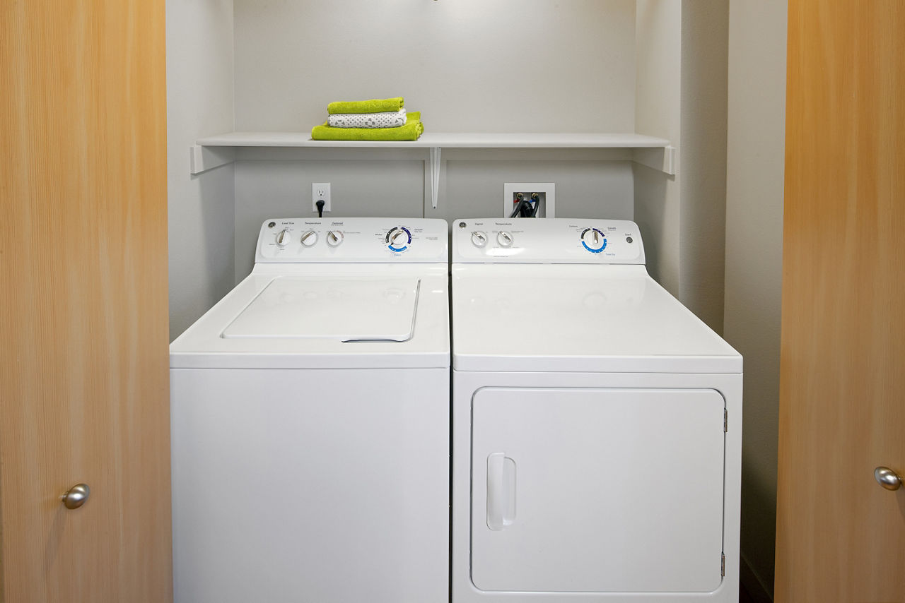 Laundry room at The Tennyson At Crescent Village Apartments