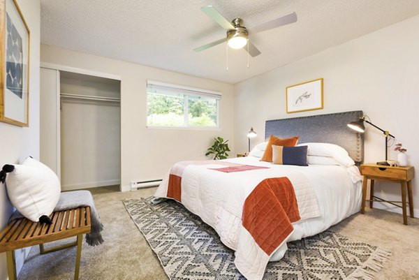 Cozy bedroom with modern decor at Lineage at Willow Creek Apartments