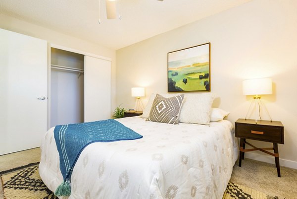 Cozy bedroom with modern furnishings at Lineage at Willow Creek Apartments in Greystar community