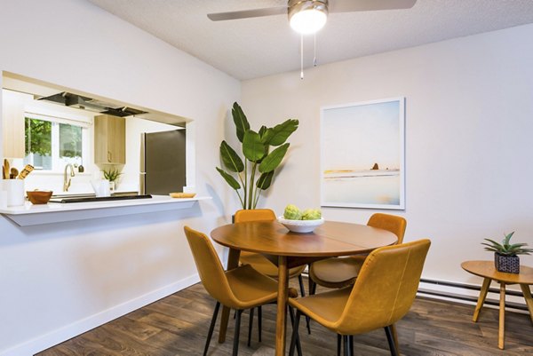 Elegant dining room with modern lighting and hardwood floors in Lineage at Willow Creek Apartments