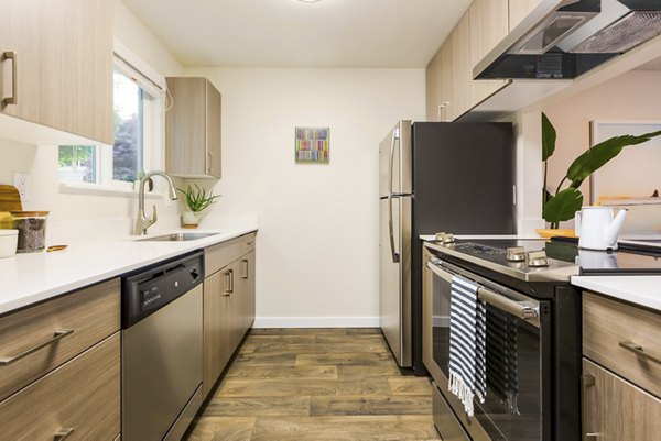 Modern kitchen with stainless steel appliances at Lineage at Willow Creek Apartments