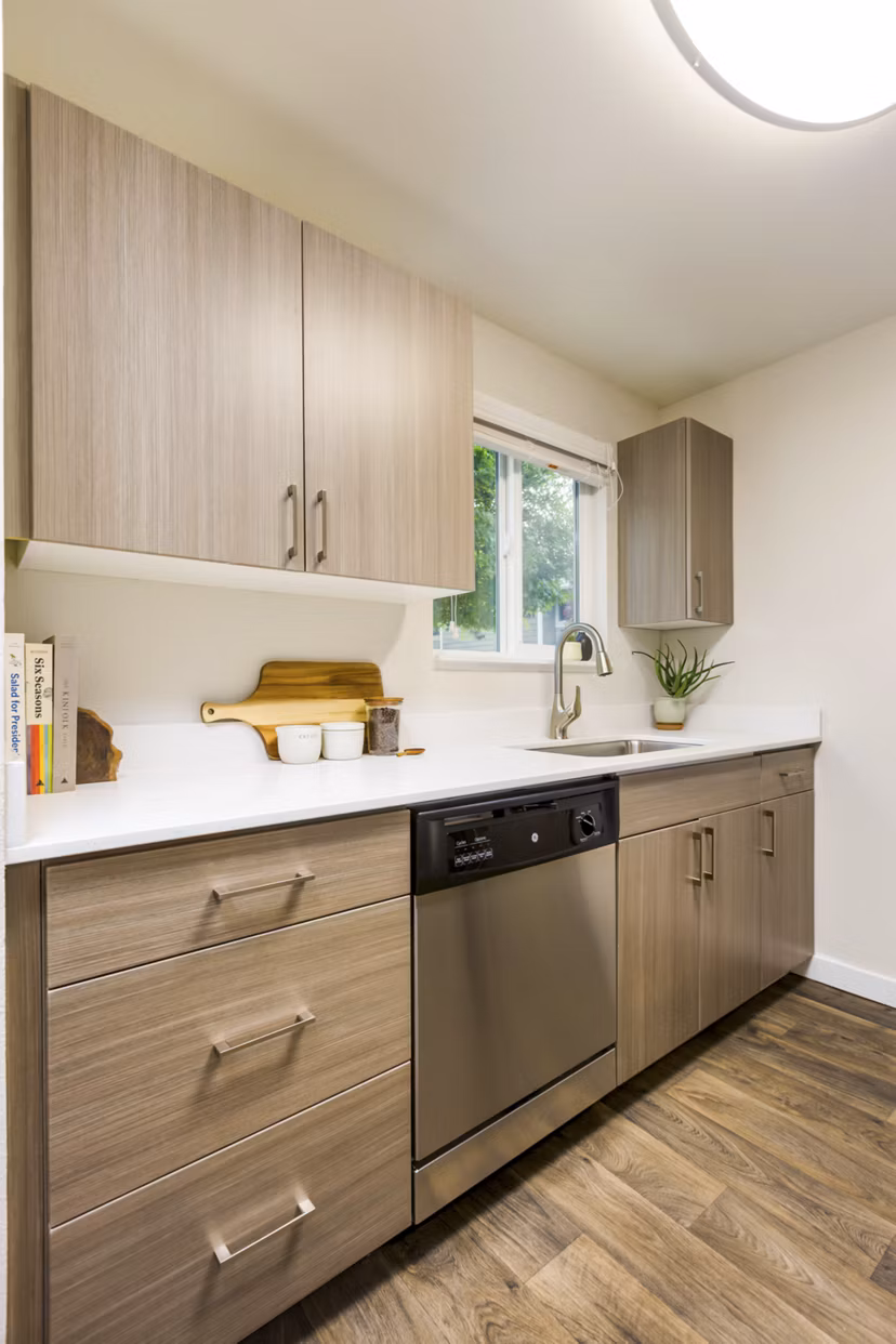 Lineage at Willow Creek Apartments kitchen featuring modern appliances and sleek countertops
