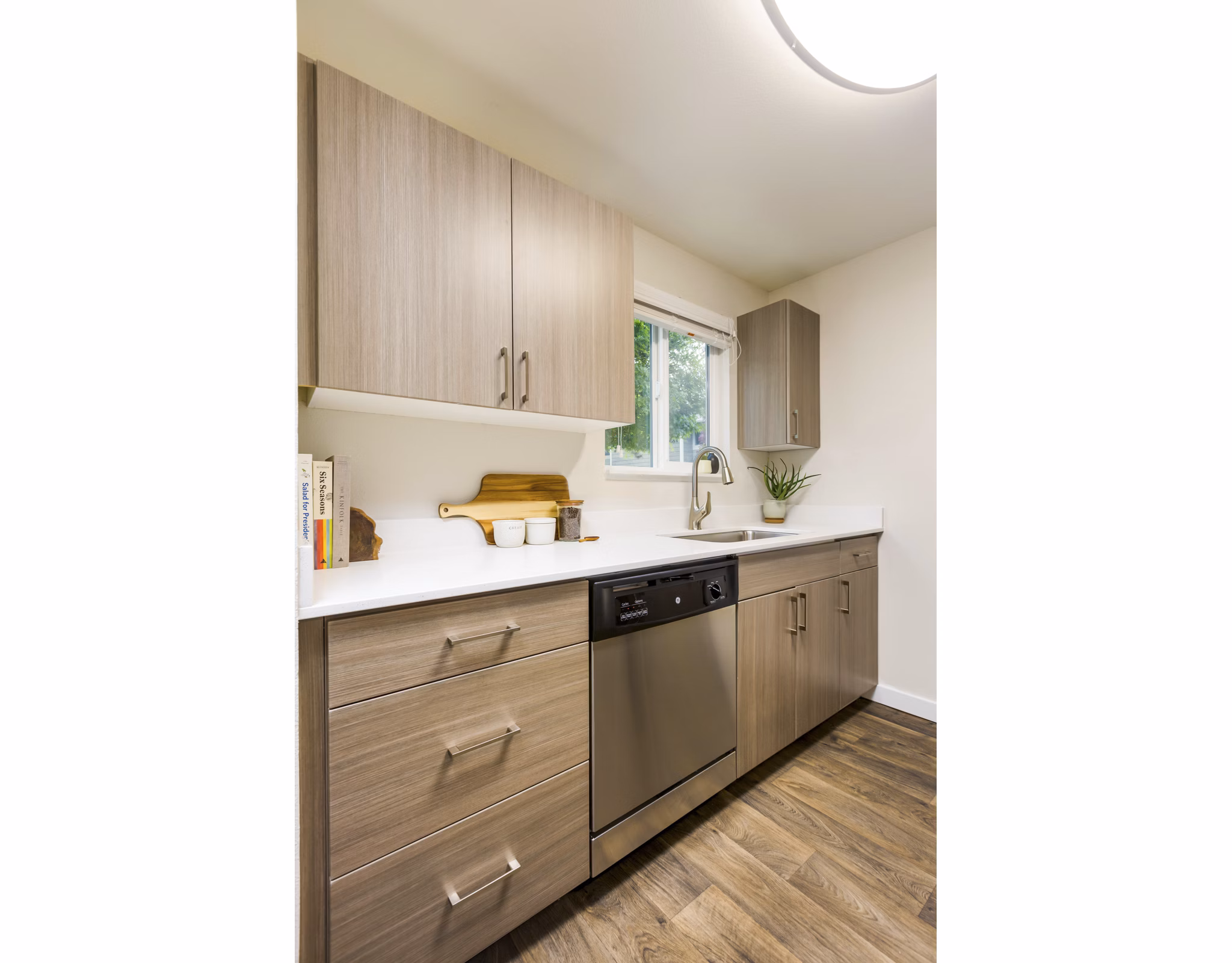 Lineage at Willow Creek Apartments kitchen featuring modern appliances and sleek countertops