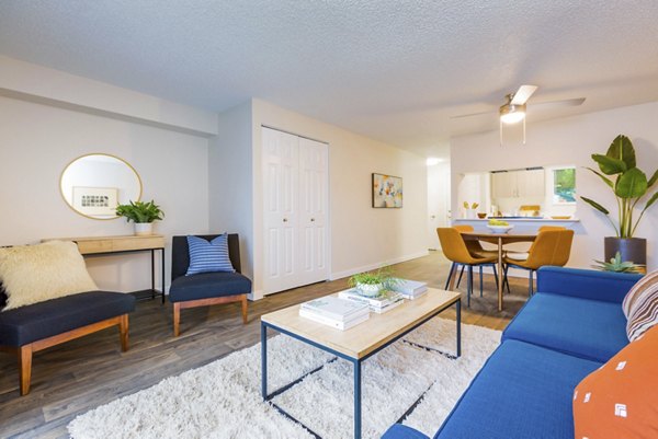 Spacious living room with modern furnishings in Lineage at Willow Creek Apartments