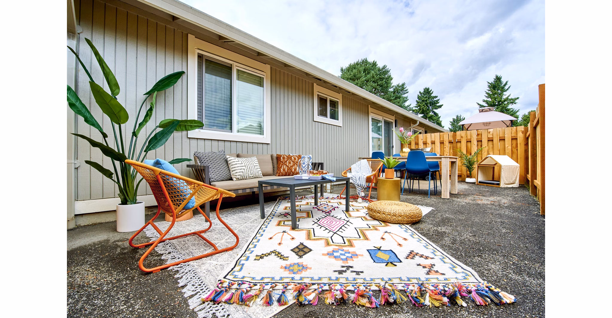 Patio area with cozy seating and greenery at Lineage at Willow Creek Apartments