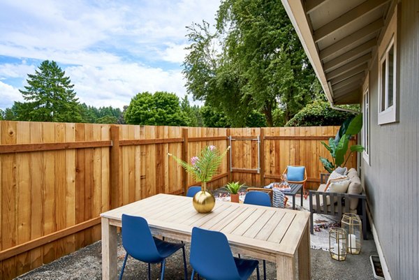 Relaxing patio area with comfortable seating at Lineage at Willow Creek Apartments