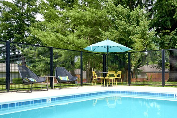 Heated leisure pool area with lounge chairs at Lineage at Willow Creek Apartments in Texas
