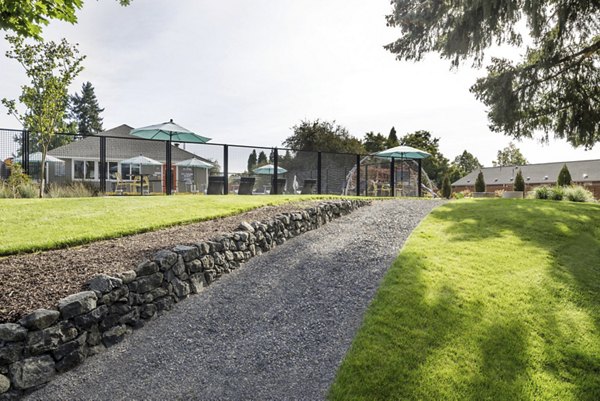 Courtyard area with modern seating and lush greenery at Lineage at Willow Creek Apartments