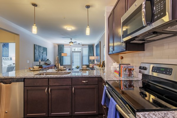 Modern kitchen with stainless steel appliances at Fountains Matthews Apartments