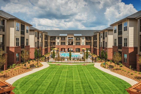 Luxurious swimming pool at Fountains Matthews Apartments with surrounding lounge chairs, offering a serene retreat for residents