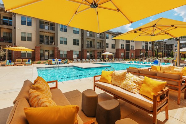 Resort-style pool with lounge chairs at Fountains Matthews Apartments, perfect for relaxation and recreation in a luxury setting