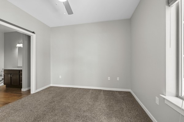 Cozy bedroom with elegant decor in Confluence at Three Springs Apartments