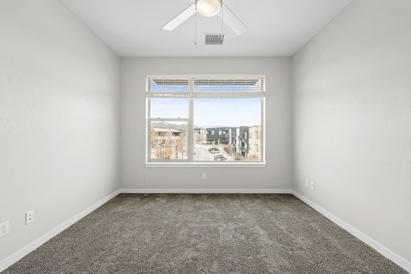 Cozy bedroom with modern decor in Confluence at Three Springs Apartments