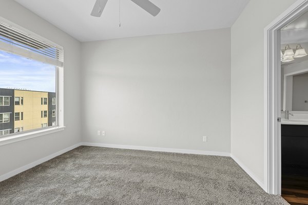 Cozy bedroom with modern furnishings at Confluence at Three Springs Apartments