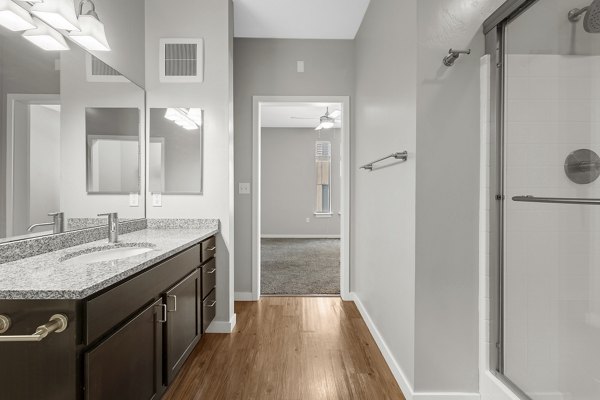 Modern bathroom with sleek fixtures at Confluence at Three Springs Apartments, a luxury property managed by Greystar