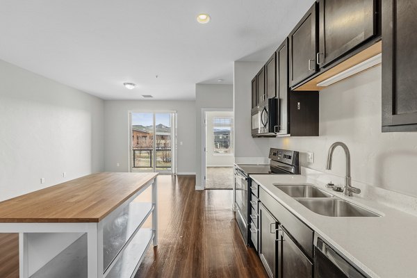 Modern kitchen with stainless steel appliances at Confluence at Three Springs Apartments