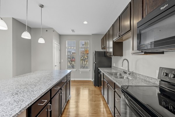 Sleek kitchen with modern appliances at Confluence at Three Springs Apartments