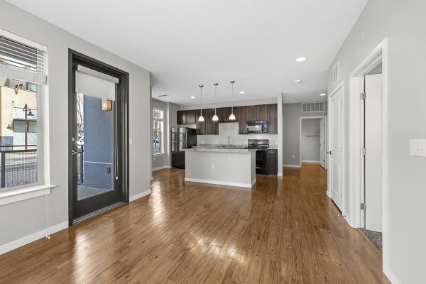 Elegant living room with modern furniture and large windows at Confluence at Three Springs Apartments, offering luxury living