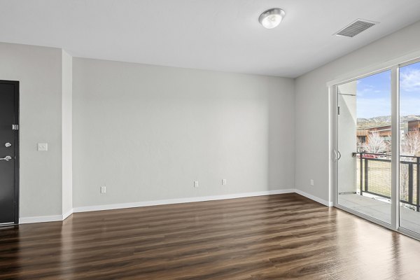 Spacious living room with modern furnishings in Confluence at Three Springs Apartments